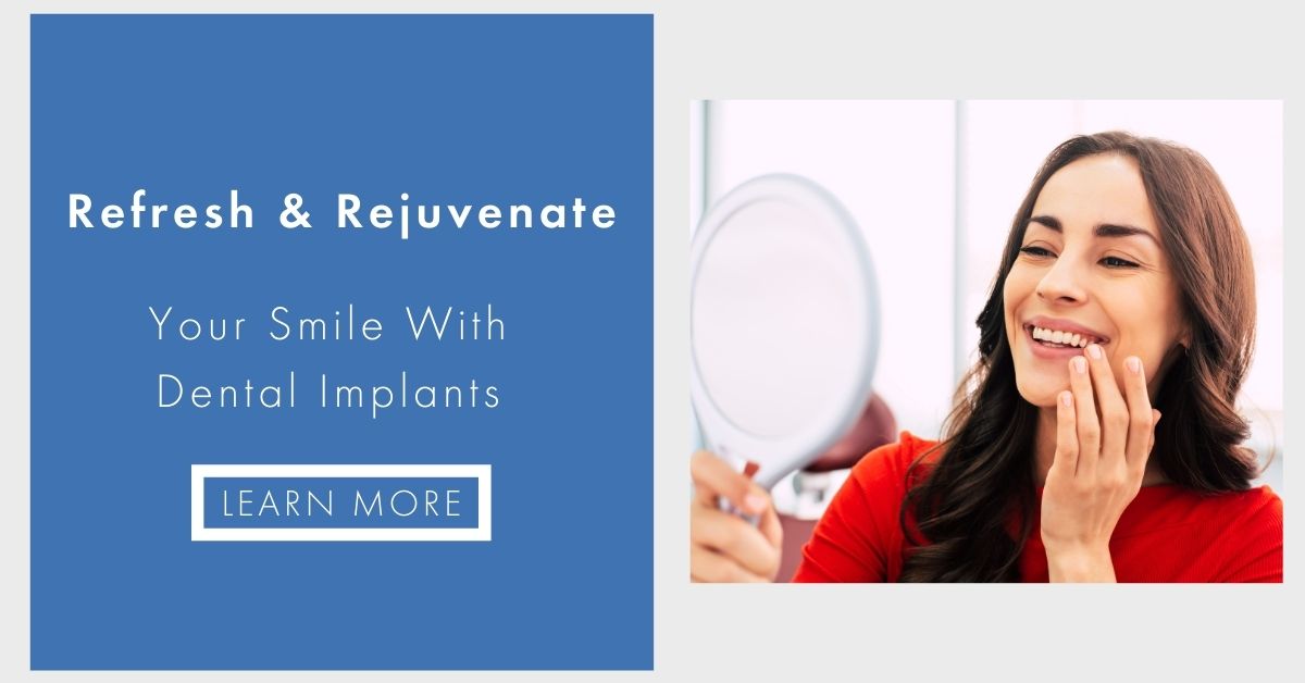 This is a digital advertisement featuring a woman in the foreground smiling at a mirror with her reflection visible, holding a makeup brush, set against a background image of a dental implant procedure. The text overlay on the ad reads  Refresh   Rejuvenate Your Smile with Dental Implants.